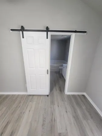 a view of walk in closet with wooden floor