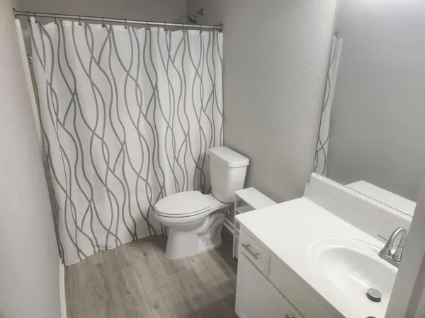 a white toilet sitting next to a white sink
