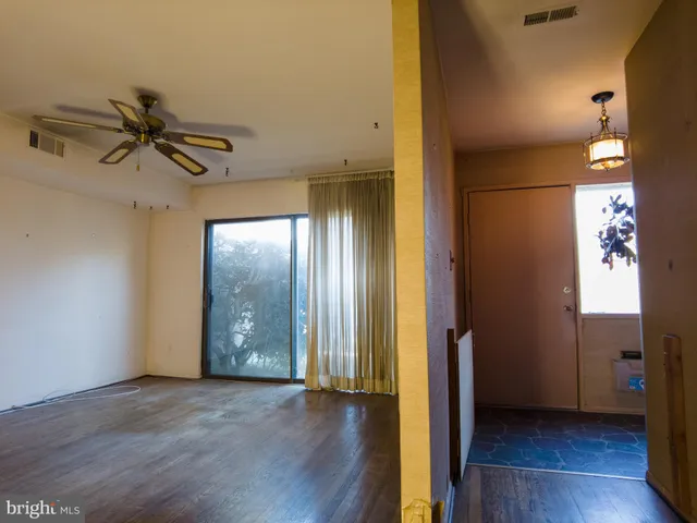 a view of an empty room and wooden floor