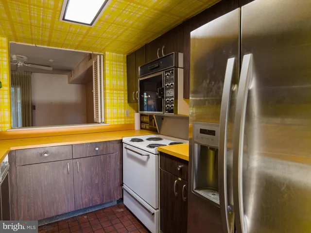 a kitchen with a sink and a refrigerator