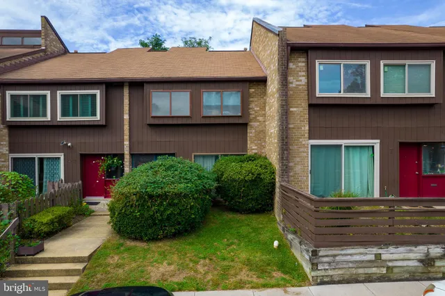 a view of a brick house with potted plants