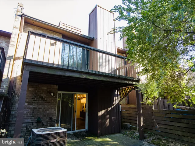 a view of a backyard with a deck and a garden