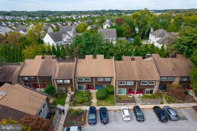 an aerial view of residential house with outdoor space and parking