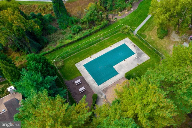 an aerial view of a house with a yard and garden