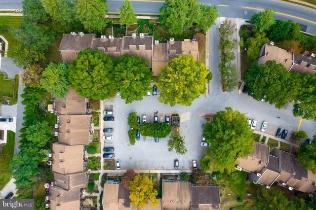an aerial view of multiple houses with yard