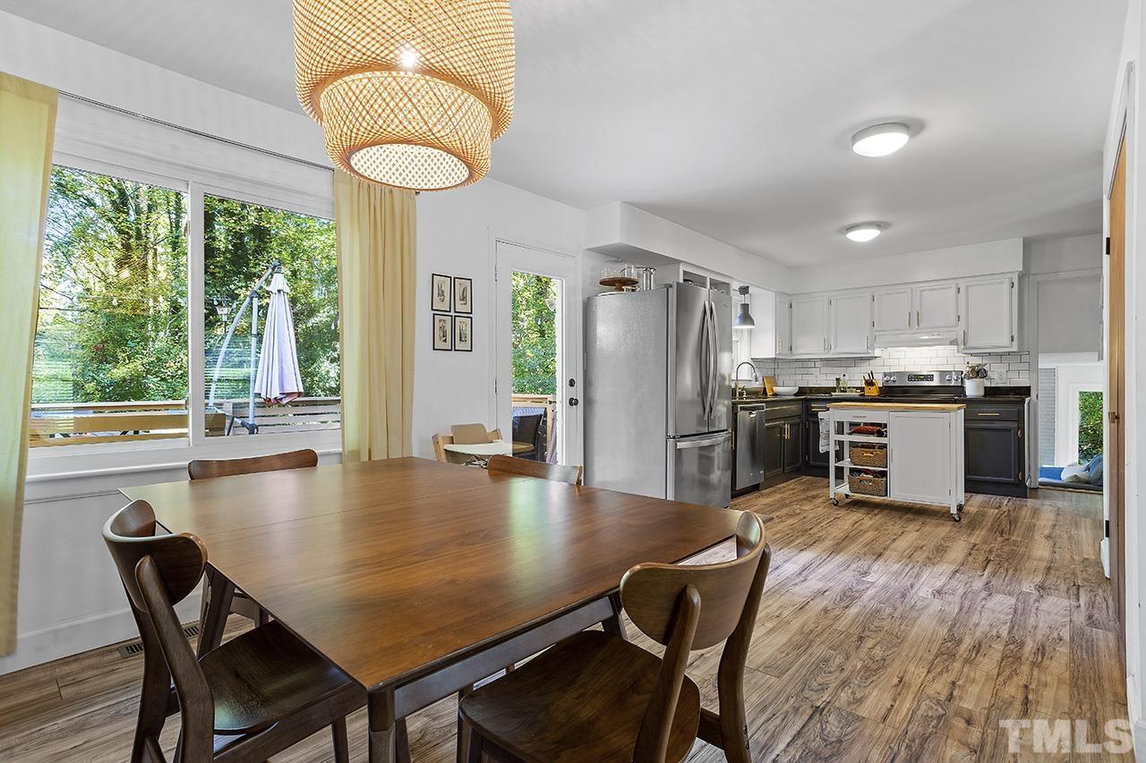 4304 Pickwick Drive Raleigh, NC 27613 - Photo 15 of 34 a kitchen with a table chairs refrigerator and microwave