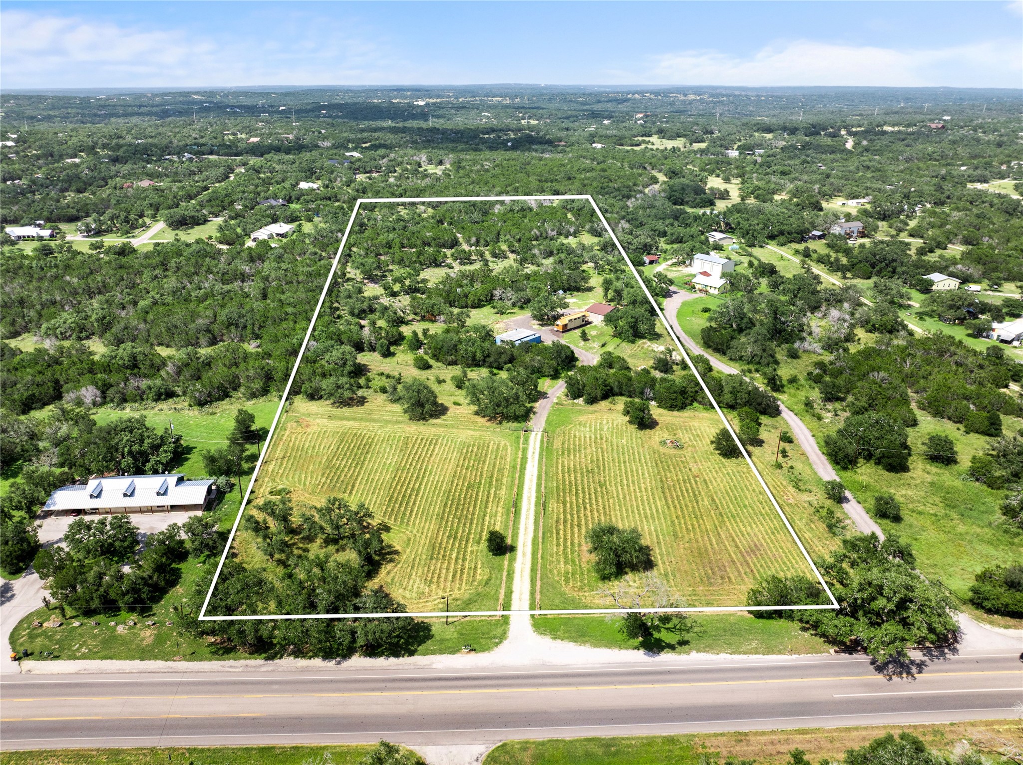 8200 Ranch Road 12 San Marcos, TX 78666 - Photo 1 of 40 A spacious, verdant lot awaits your vision, bordered by a quiet road and surrounded by lush trees.