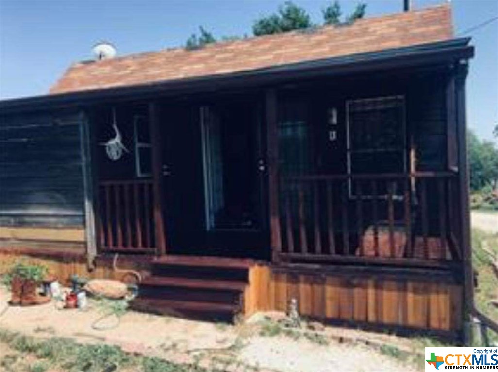 a view of a house with a wooden fence