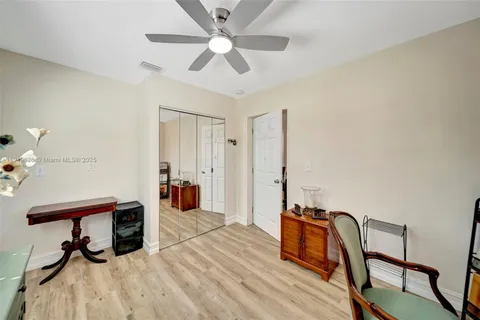 a spacious bedroom with a bed and wooden floors