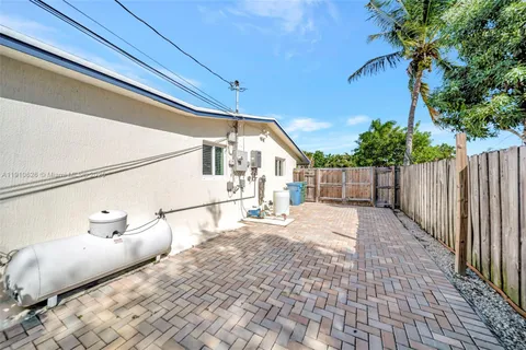 a kitchen with stainless steel appliances kitchen island granite countertop a stove top oven a sink a dining table and chairs with wooden floor