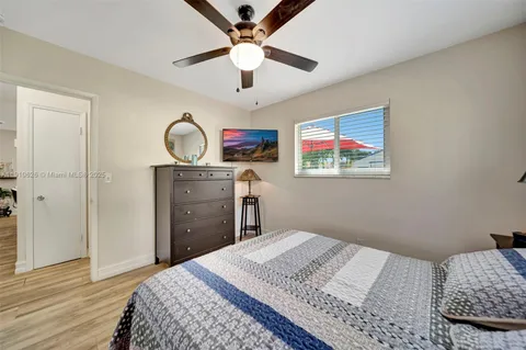 a view of backyard with a barn plants and large tree