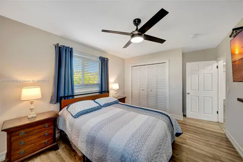 a view of a patio with a table and chairs under an umbrella