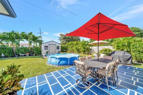 a backyard of a house with outdoor seating