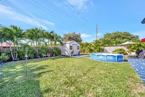 an aerial view of residential house with outdoor space and swimming pool