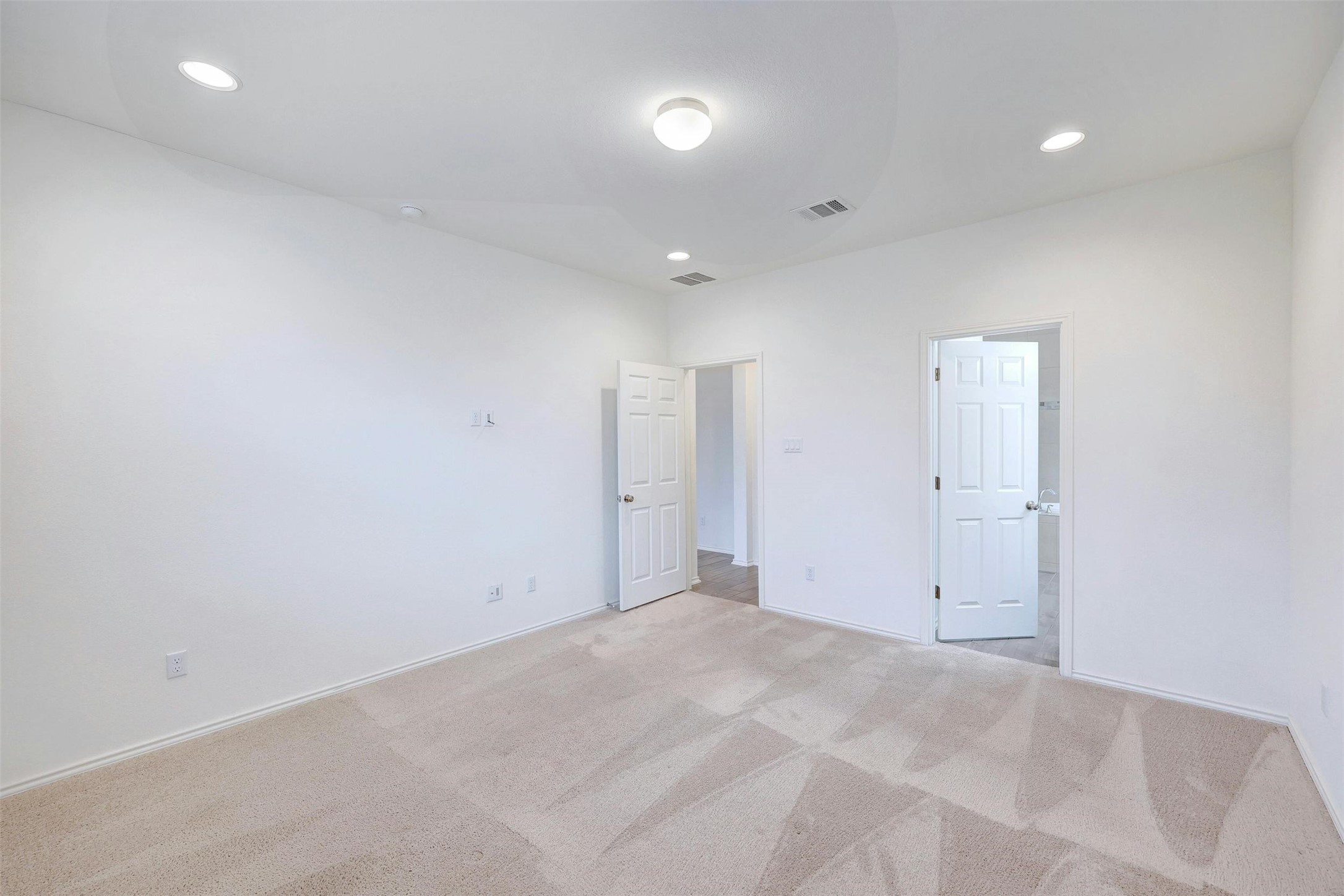 307 Simmental Loop Hutto, TX 78634 - Photo 17 of 34 A spacious, naturally illuminated room featuring recessed lighting and plush carpet, ready for personalization.