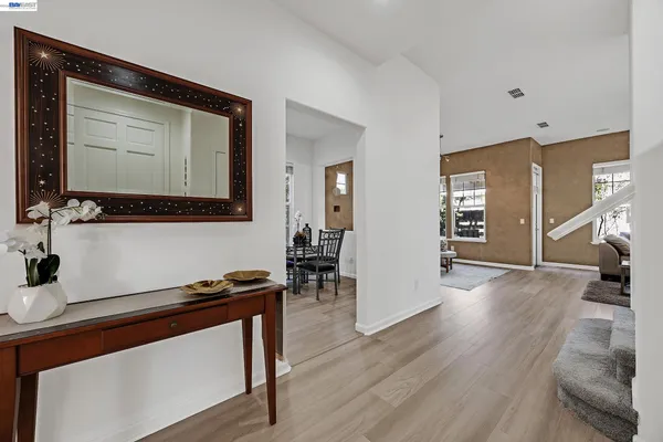 a view of a livingroom with wooden floor and furniture