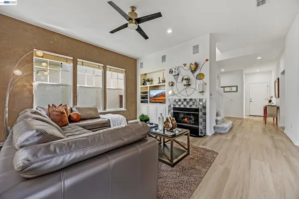 a living room with furniture a fireplace and a flat screen tv