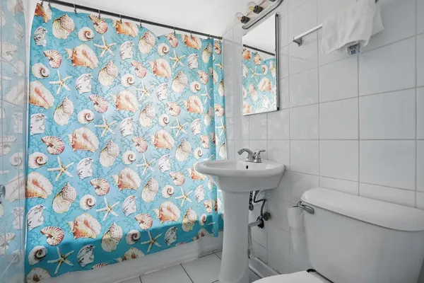 a bathroom with a sink toilet and shower