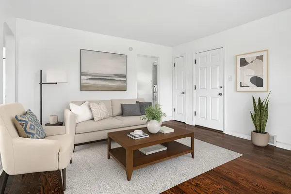a view of an empty room with wooden floor