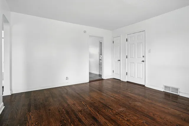 an empty room with wooden floor