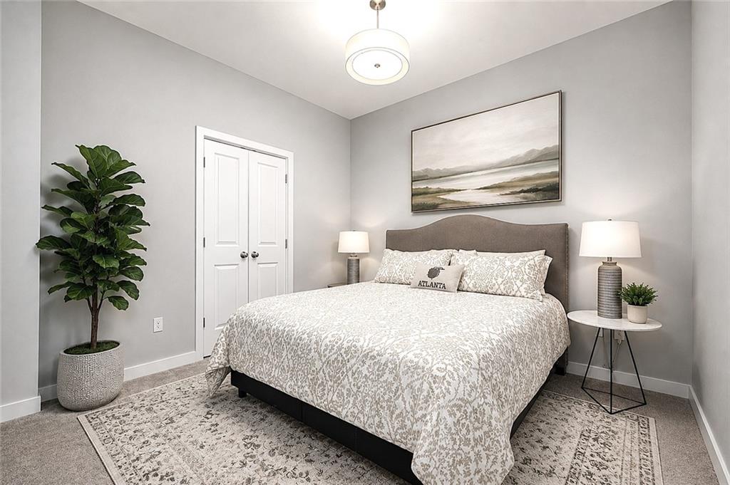 3300 Windy Ridge Parkway Southeast, Unit 1112 Atlanta, GA 30339 - Photo 22 of 43 a bedroom with bed and a potted plant