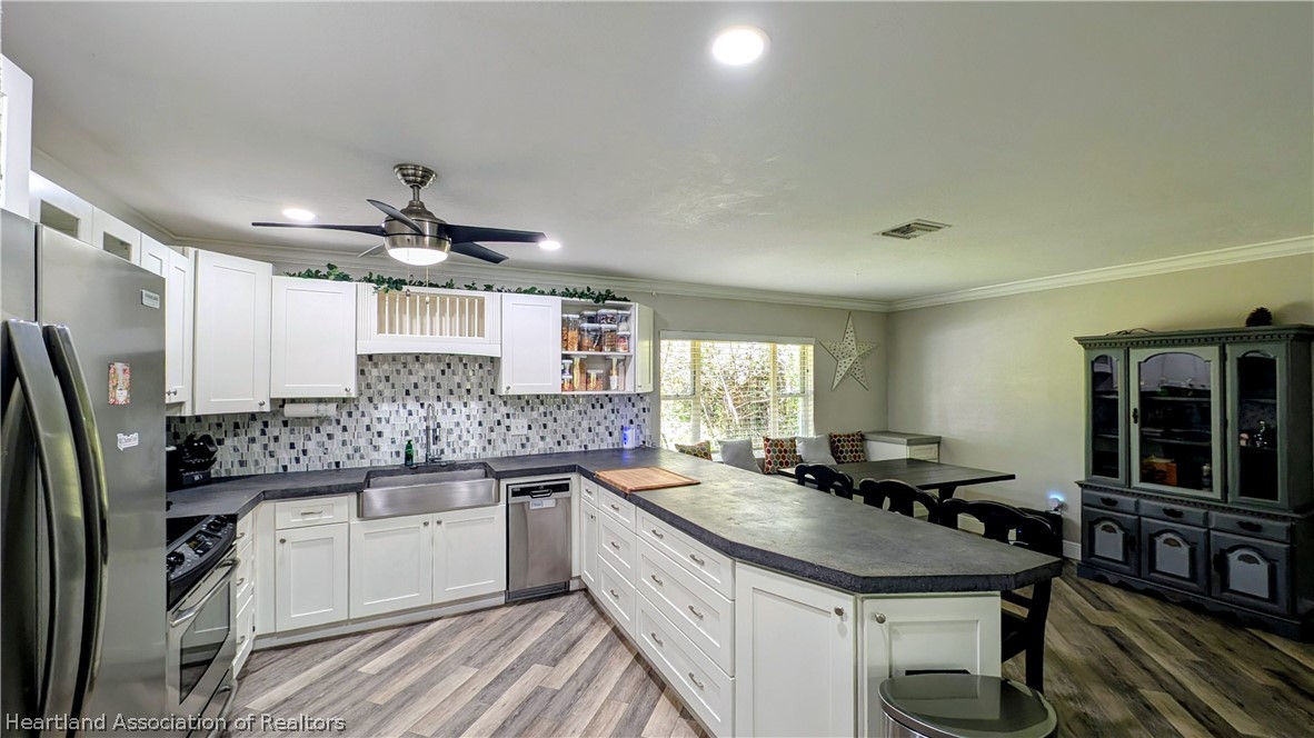 6218 Apple Road Sebring, FL 33875 - Photo 13 of 40 a kitchen with stainless steel appliances granite countertop a sink and cabinets