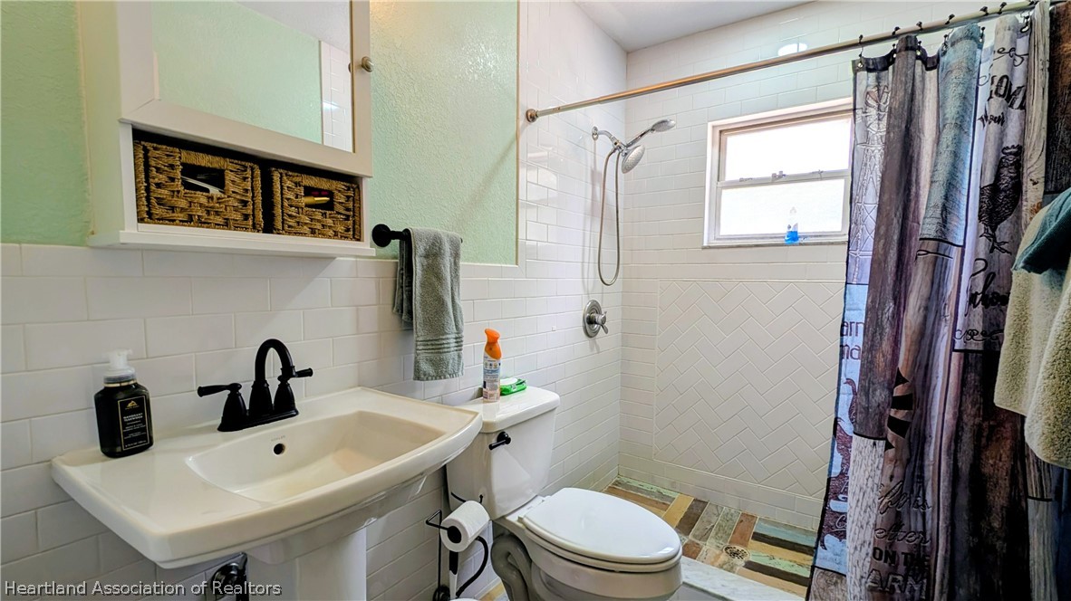 6218 Apple Road Sebring, FL 33875 - Photo 21 of 40 a bathroom with a sink mirror and toilet