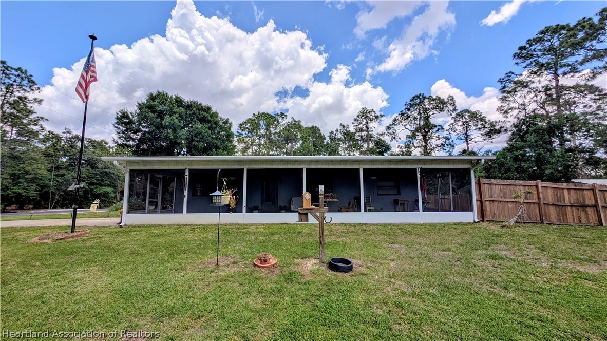 6218 Apple Road Sebring, FL 33875 - Photo 3 of 40 a front view of a house with garden