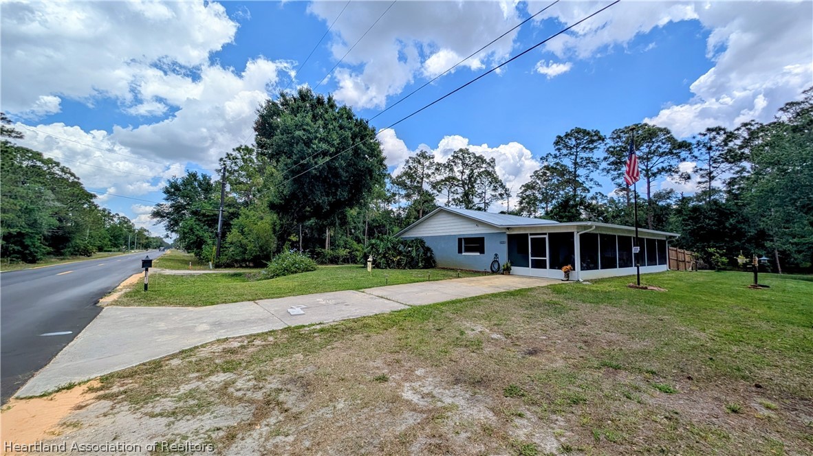 6218 Apple Road Sebring, FL 33875 - Photo 31 of 40 a front view of a house with a yard and trees