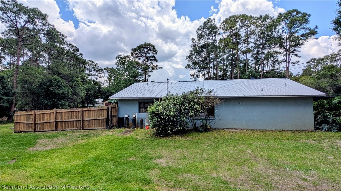 6218 Apple Road Sebring, FL 33875 - Photo 33 of 40 a front view of a house with garden