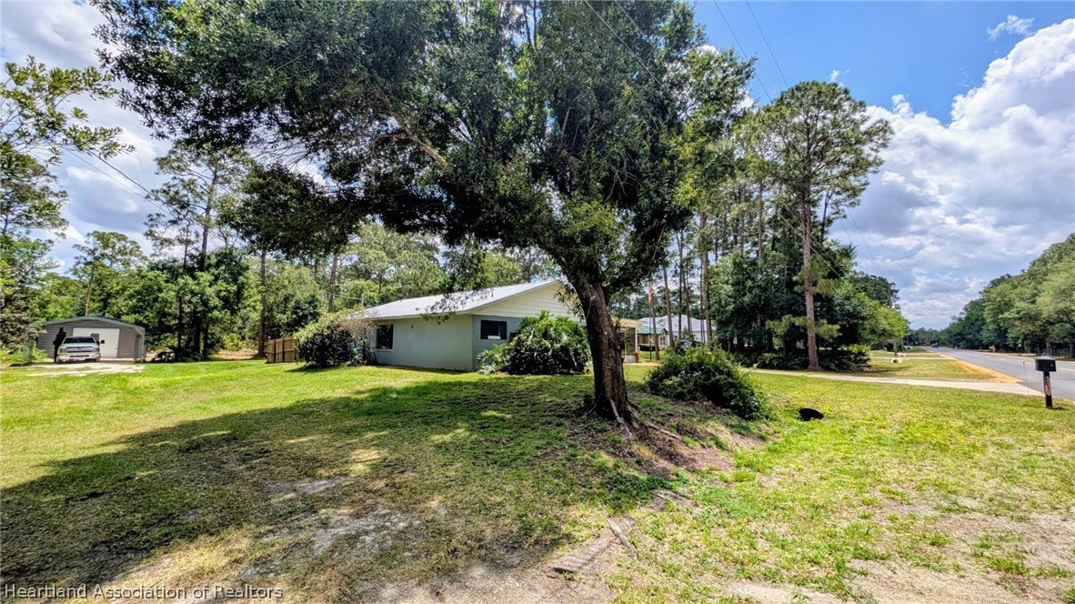 6218 Apple Road Sebring, FL 33875 - Photo 38 of 40 a view of a house with a yard and a large tree