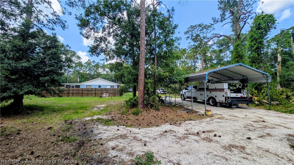 6218 Apple Road Sebring, FL 33875 - Photo 6 of 40 a view of a house with a yard and sitting area