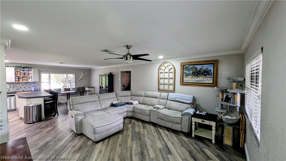 6218 Apple Road Sebring, FL 33875 - Photo 8 of 40 a living room with furniture and a wooden floor