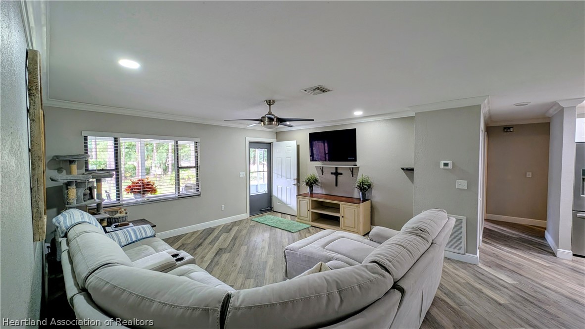 6218 Apple Road Sebring, FL 33875 - Photo 9 of 40 a living room with furniture and a flat screen tv