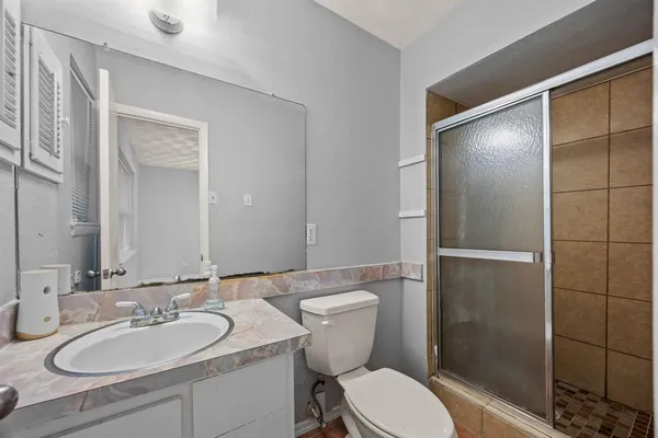 a bathroom with a sink toilet and shower