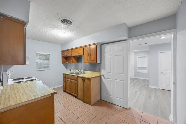a kitchen with stainless steel appliances granite countertop a stove and a sink