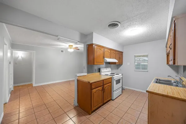 a kitchen that has a sink and a stove in it