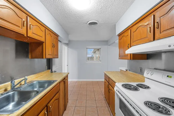 a kitchen that has a sink and a stove