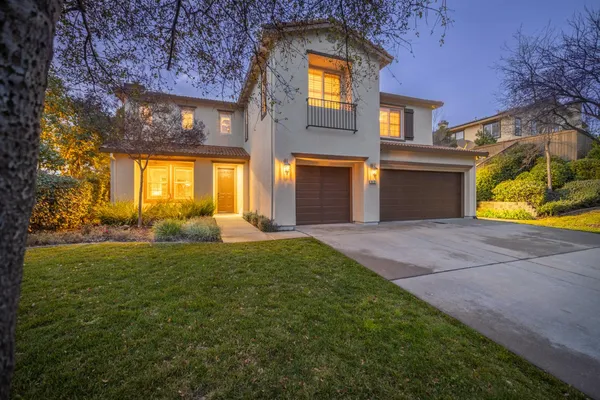a front view of a house with a yard and garage