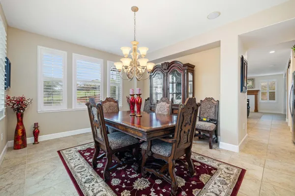 a view of a dining room with furniture and a chandelier