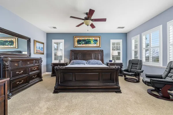 a living room with furniture a bed and a window