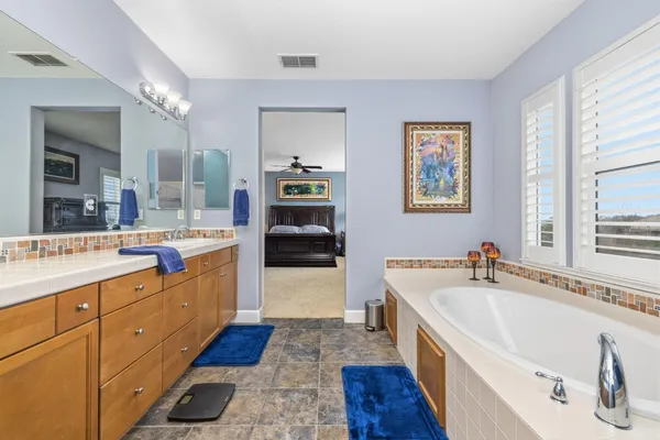a large white kitchen with a large window