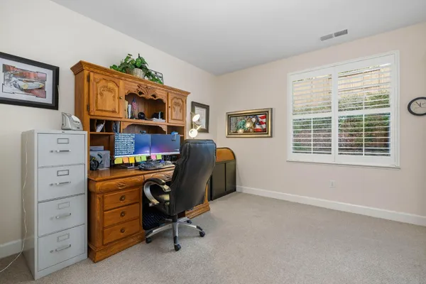 a view of workspace with furniture and a window