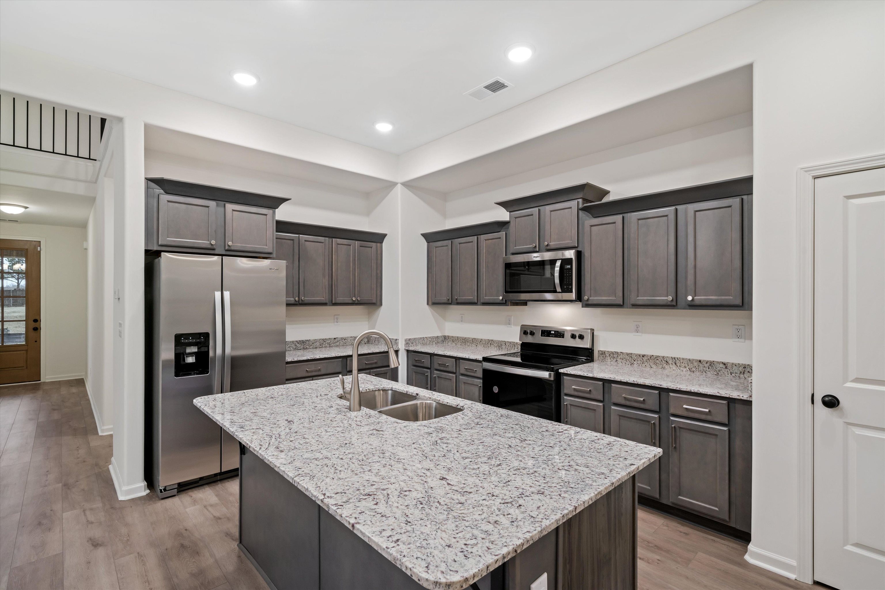 300 Maple Street Oakland, TN 38060 - Photo 13 of 27 a kitchen with stainless steel appliances granite countertop a kitchen island hardwood floor sink and stove