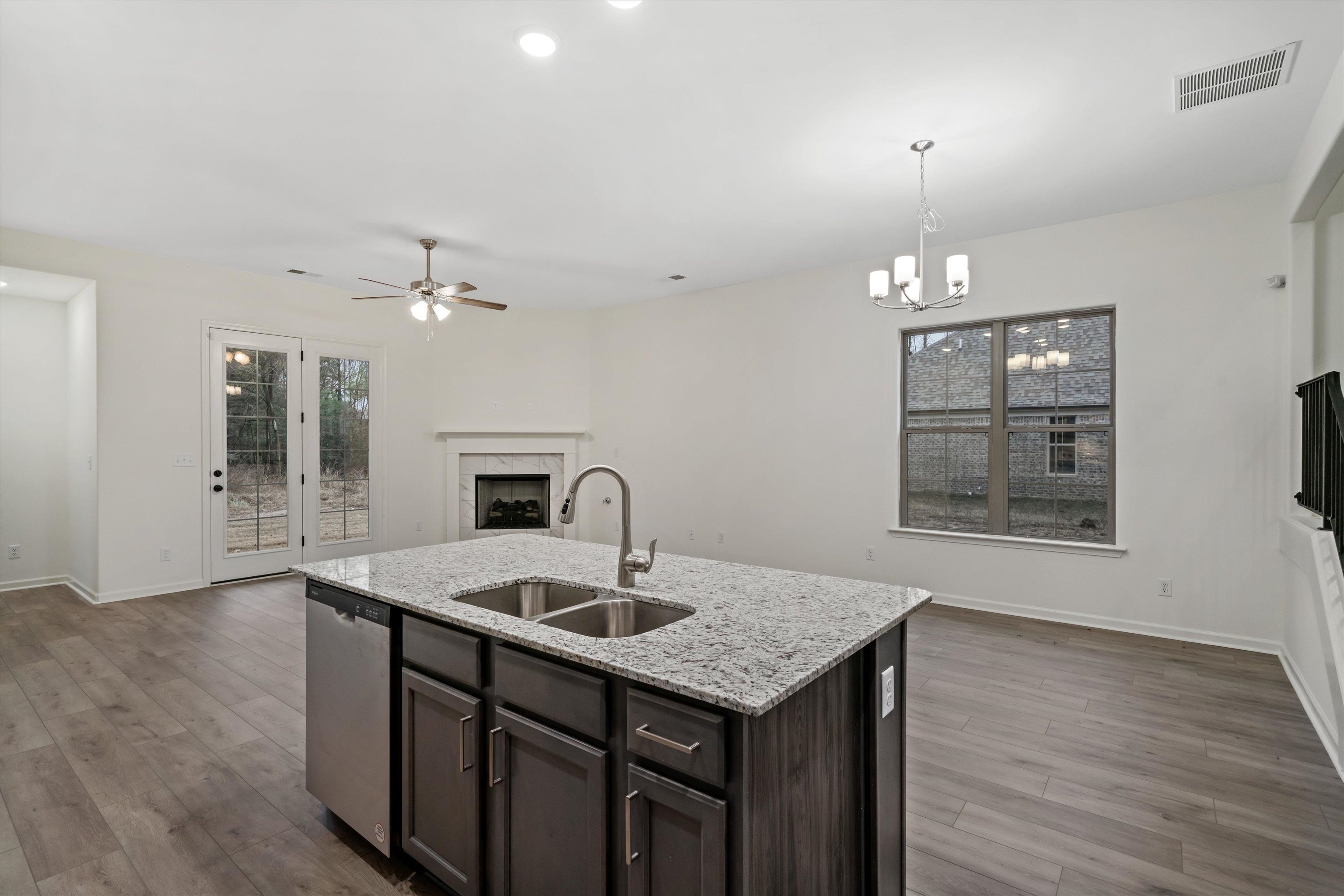 300 Maple Street Oakland, TN 38060 - Photo 14 of 27 a kitchen with a sink chandelier and wooden floor