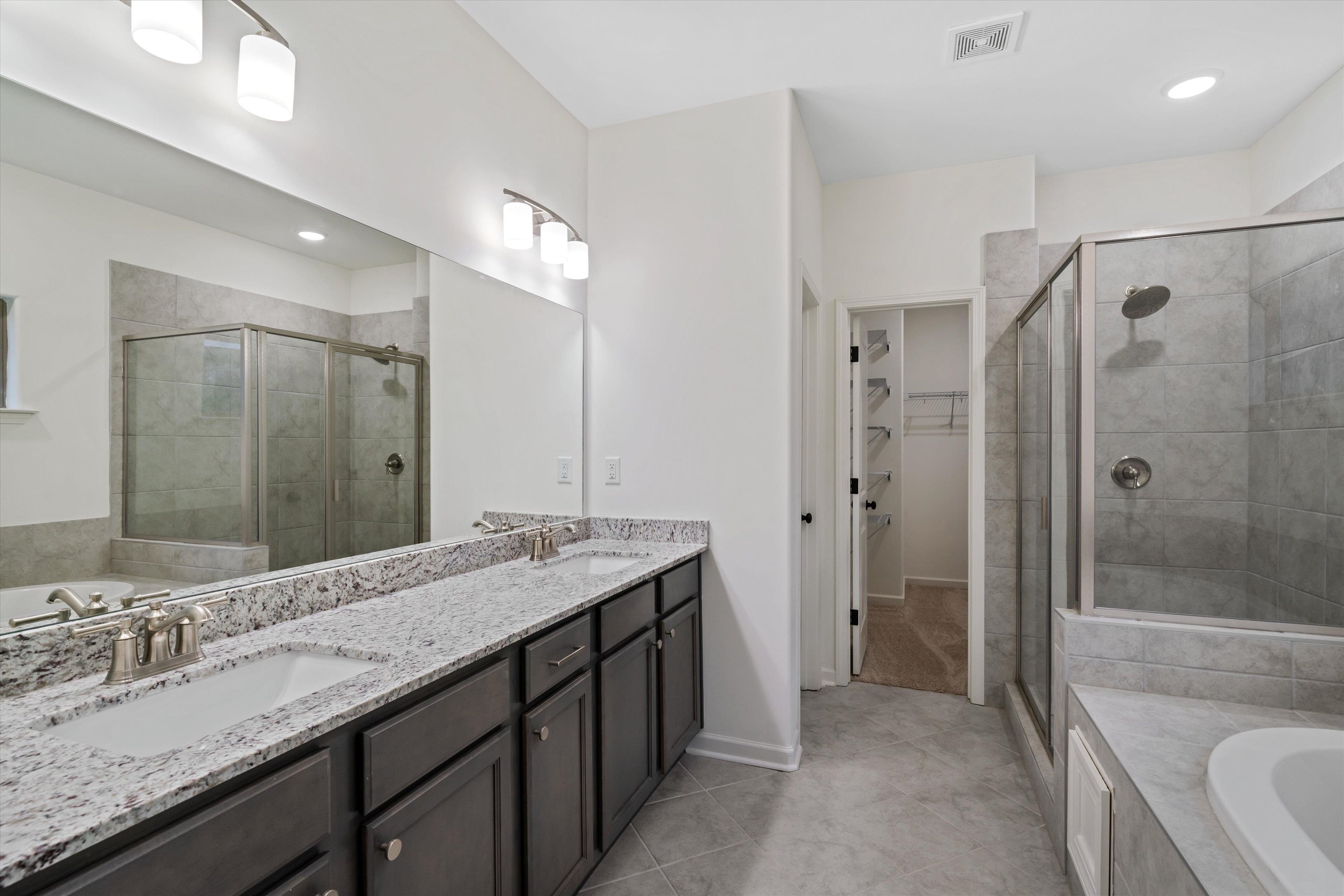300 Maple Street Oakland, TN 38060 - Photo 18 of 27 a bathroom with a granite countertop sink mirror and shower