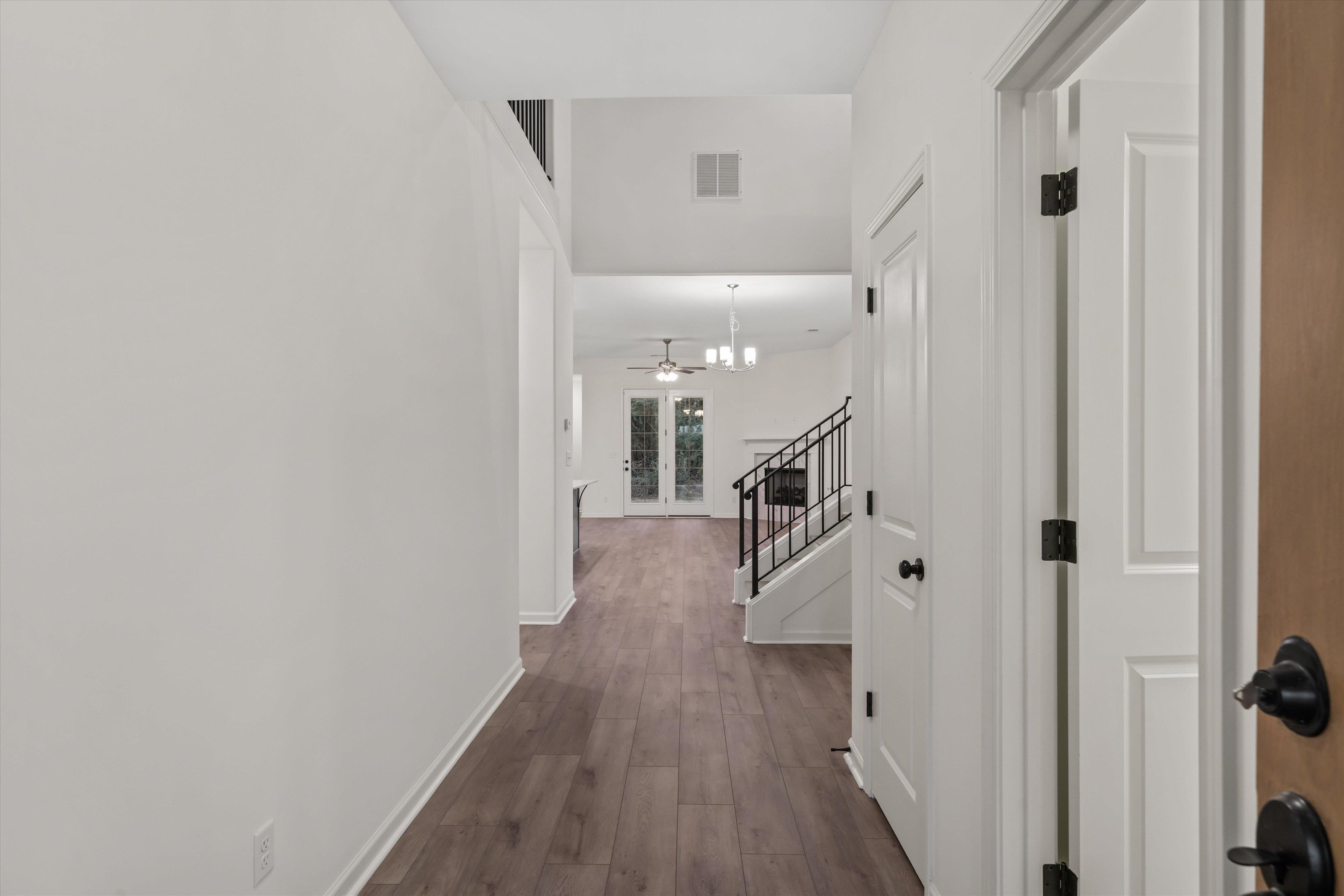 300 Maple Street Oakland, TN 38060 - Photo 3 of 27 a hallway with wooden floor and staircase