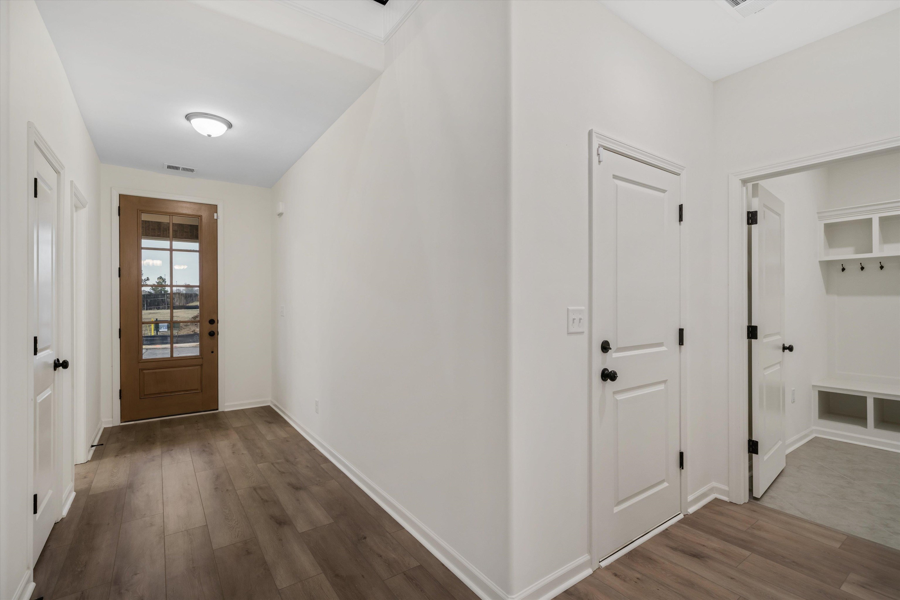300 Maple Street Oakland, TN 38060 - Photo 4 of 27 a view of a hallway with wooden floor