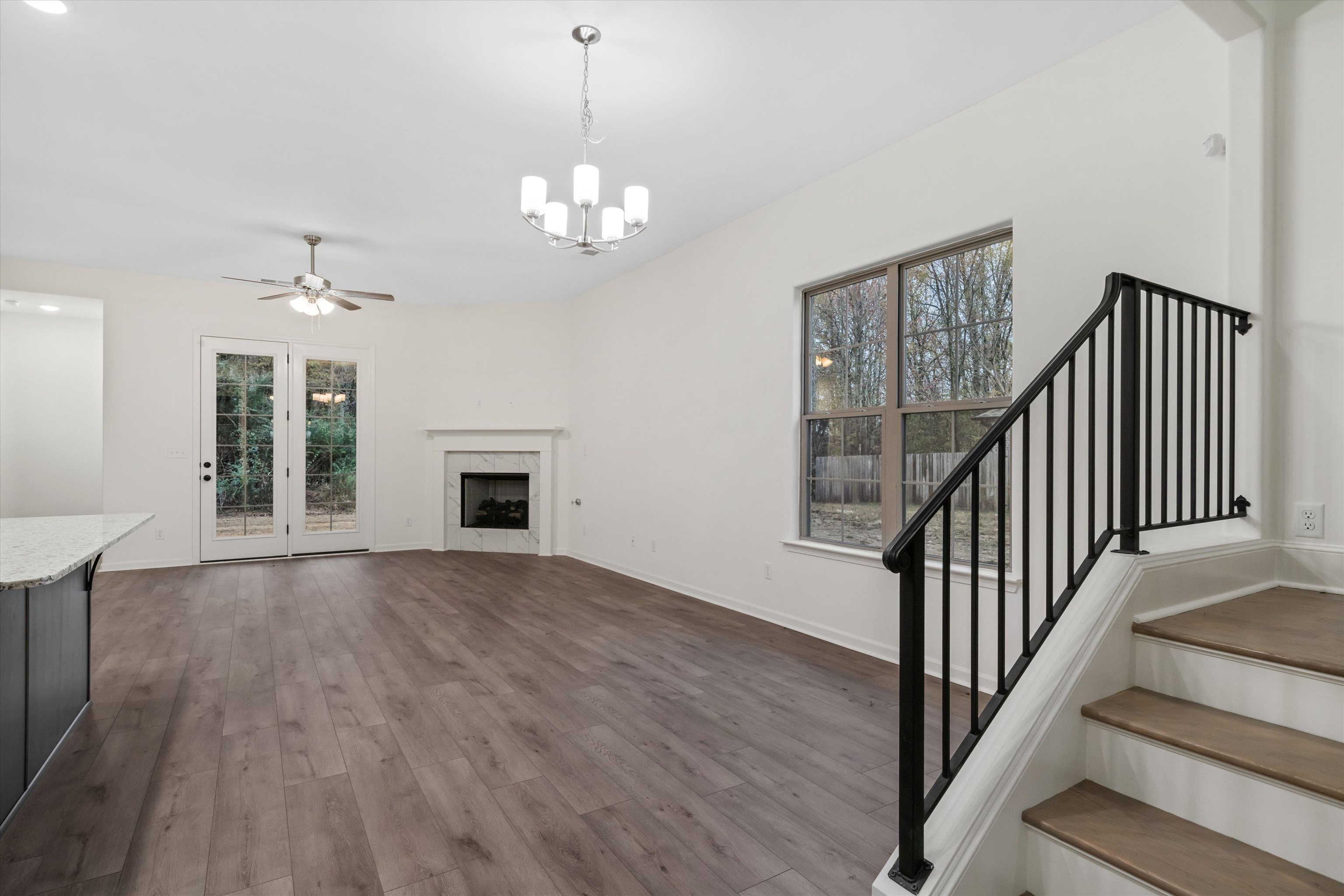 300 Maple Street Oakland, TN 38060 - Photo 6 of 27 a view of an empty room with wooden floor and a window