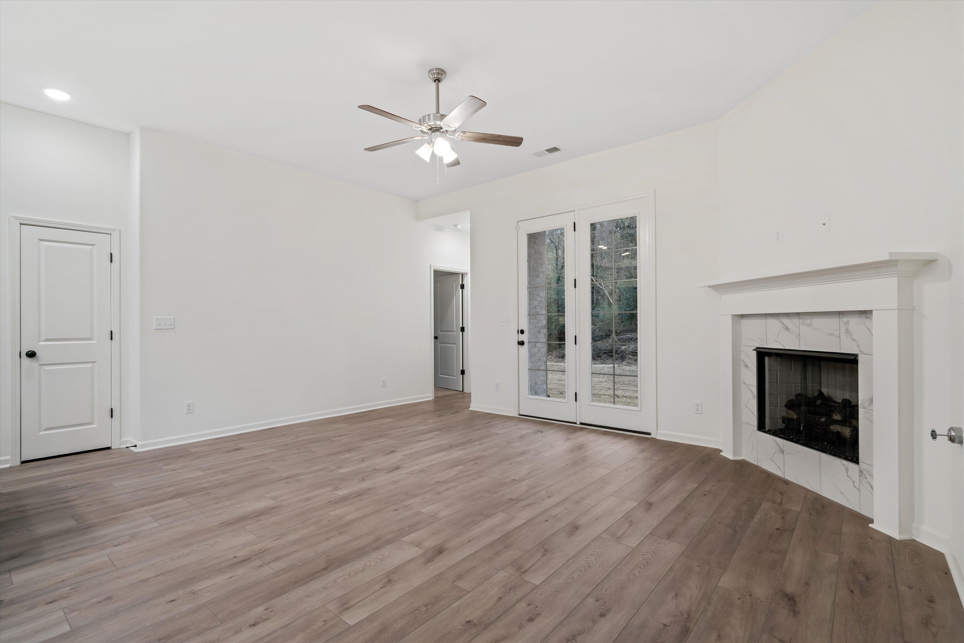 300 Maple Street Oakland, TN 38060 - Photo 10 of 27 a view of an empty room with a fireplace and a window